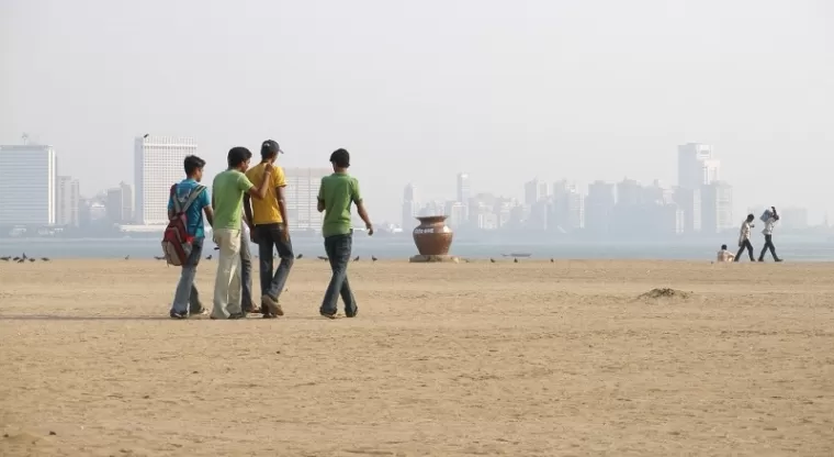 Visitors walking on Girgaon Chowpatty beach, Mumbai